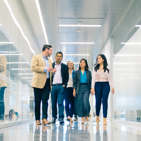 Group of students walking down a hallway